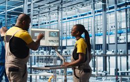 Industry 4.0 solar panels plant engineers work together...