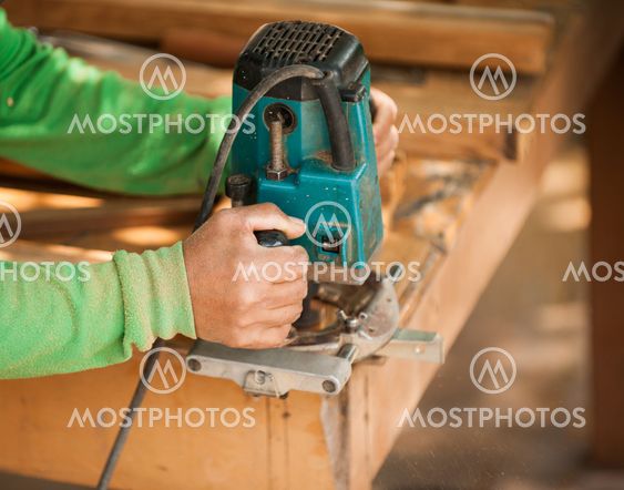 Hands of a carpenter planed wood, workplace