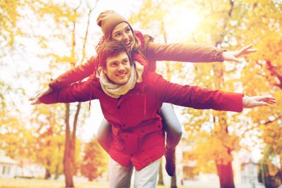 happy young couple having fun in autumn park