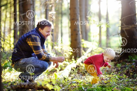 Father and his son walking during the hiking activities...