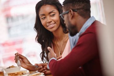 Smile, black couple and health food on date at cafe for...