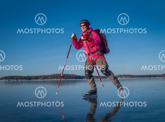 Woman ice skating on lake in Sweden
