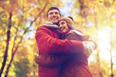 happy young couple hugging in autumn park