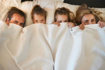 Parents, children and hide in blanket for relax, lazy...