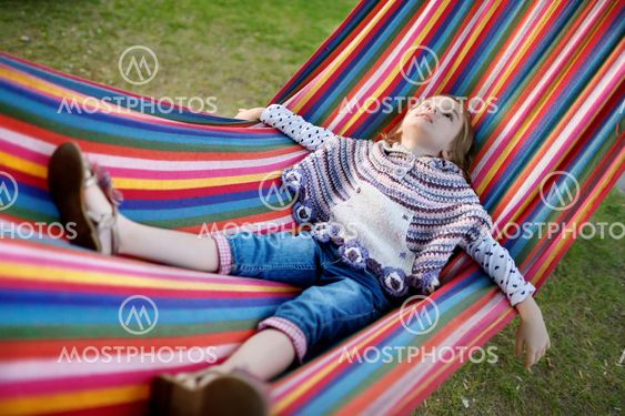 Lovely girl resting in a hammock
