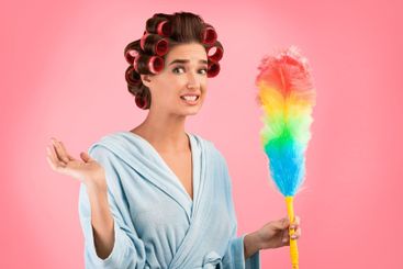Confused Housewife With Curlers Holding Feather Duster,...
