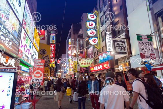 Osaka, Japan - April 2016: Tourist popular night shopping street in Osaka City at Dotonbori Namba area with illuminated neon signs and billboards alongside
