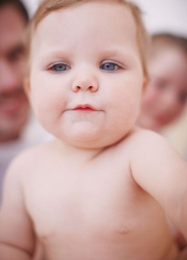 Baby, growing and closeup of portrait in home, love and...