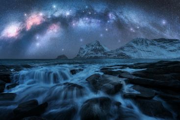 Night starry sky with Milky Way, snowy mountains,...
