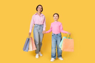Mother and daughter enjoy shopping together with...