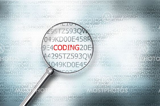 reading coding on computer screen with a magnifying glass