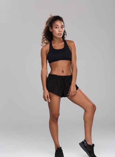 Full length portrait of a strong afro american sportswoman