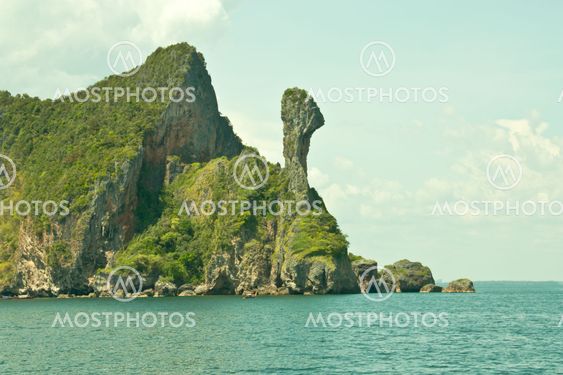 Mountains large rock in sea.
