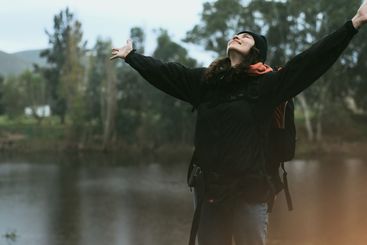 Hiking, achievement and woman with celebration in nature...