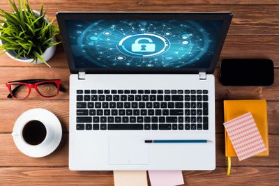 Web security and technology concept with laptop on wooden...