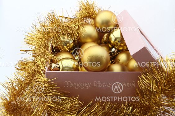 golden new year's balls to box on white background