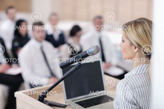 business woman standing with her staff at conference