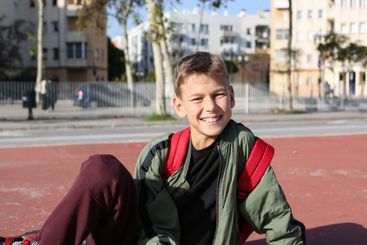 Handsome teenager standing with skateboard. Adolescent...