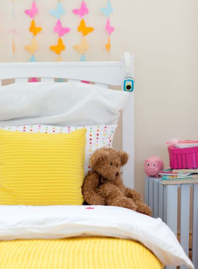 Child's bedroom with a teddy bear on the bed
