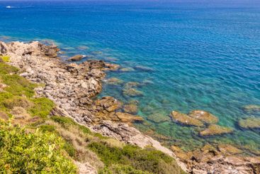 Rocky coastline with clear turquoise water of Aegean Sea