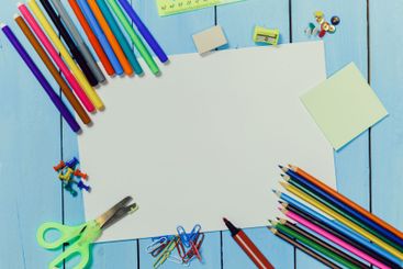 Creative workspace with colorful art supplies arranged...