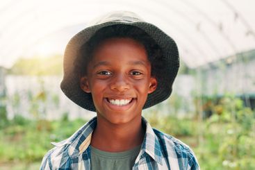 Agriculture, smile and portrait with black child in...
