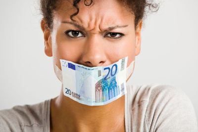 Covering mouth with a euro banknote