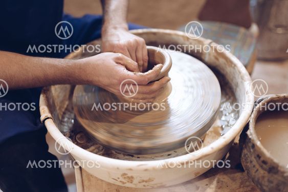 Potter making a clay vase on a potter's wheel