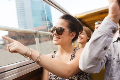 teenage girl with friends traveling by tour bus
