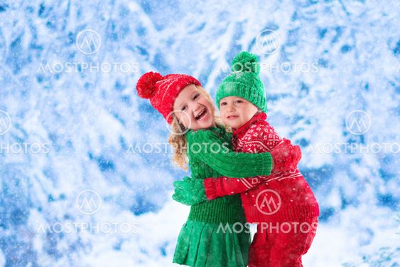 Kids playing in snowy winter forest