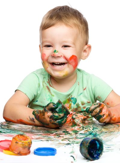 Child is grabbing some paint using fingers