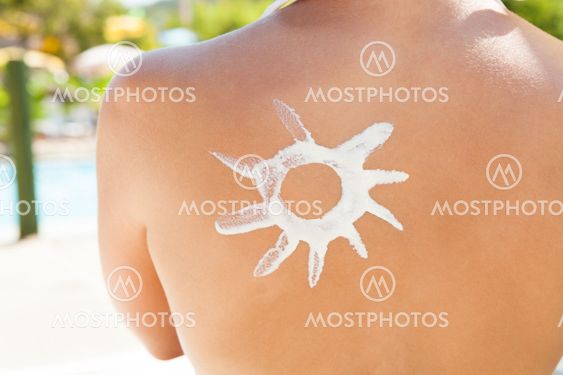 Woman With Sun Shaped Suntan Lotion On Back