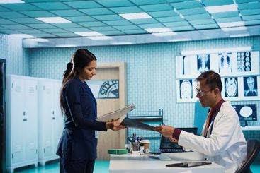 Physician expert reviewing x ray scan results in his...