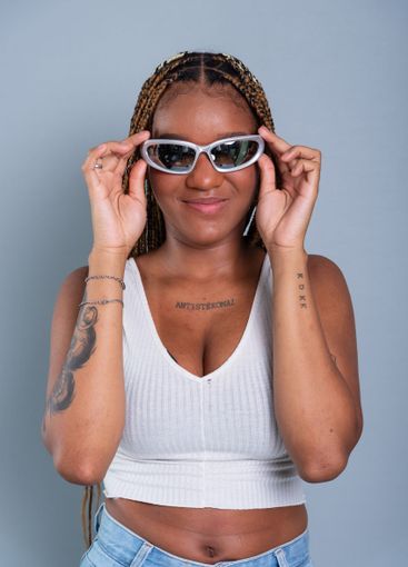 Beautiful brunette with braids in her hair, holding...