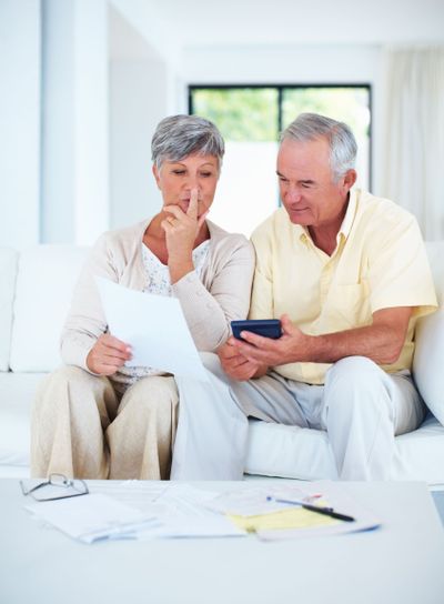 Home budgeting. Mature couple calculating domestic bills...