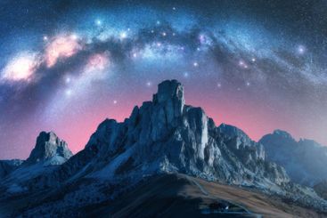 Milky Way over majestic alpine mountain range at starry...