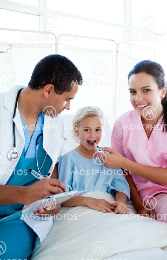 A nurse taking her female patient temperature with a thermometer