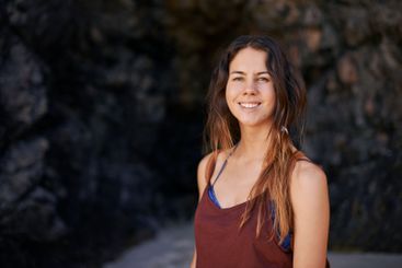 Portrait, rocks and woman with smile, travel and...