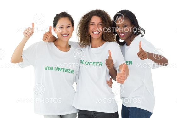 Happy team of volunteers giving thumbs up at camera