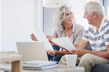 Senior, happy couple and documents with laptop for...