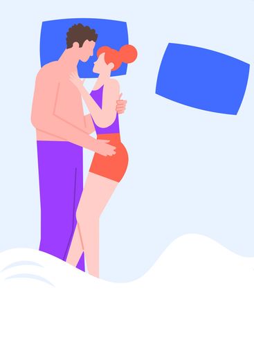 Young couple sleeping together in bed, embracing and...