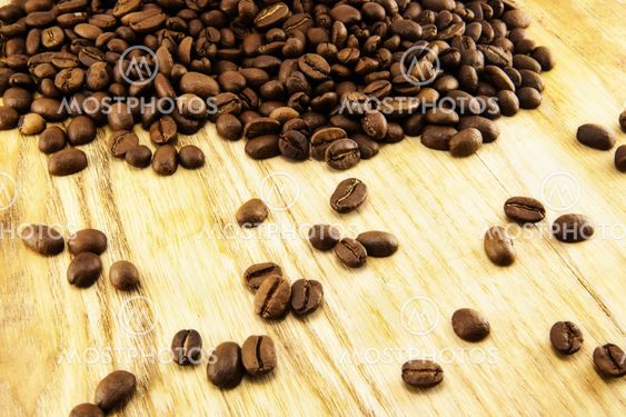Coffee beans on vintage wooden board