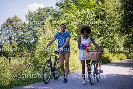 Young multiethnic couple having a bike ride in nature