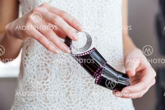 Photographic film holded by young woman photographer