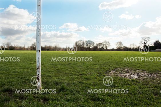 A Close Up Of A Goal Post On A Field In The Sun With Blue Sky And Clouds