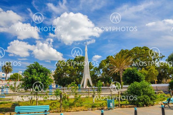 Monument with blue sky and trees near Medina in Hammamet...