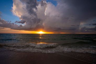 Rainstorm clouds over rough sea waters. Evening ocean...