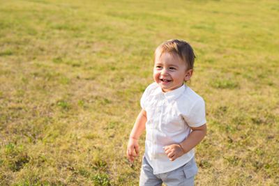 Portrait of smiling happy baby boy on natural background...
