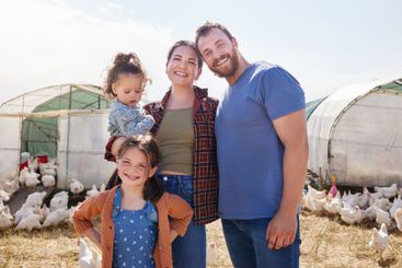 Farm, chicken and portrait of parents with children in...