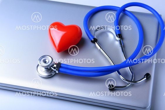 Workplace of doctor with stethoscope, red heart, laptop, rx prescription and notebook on white table. top view.